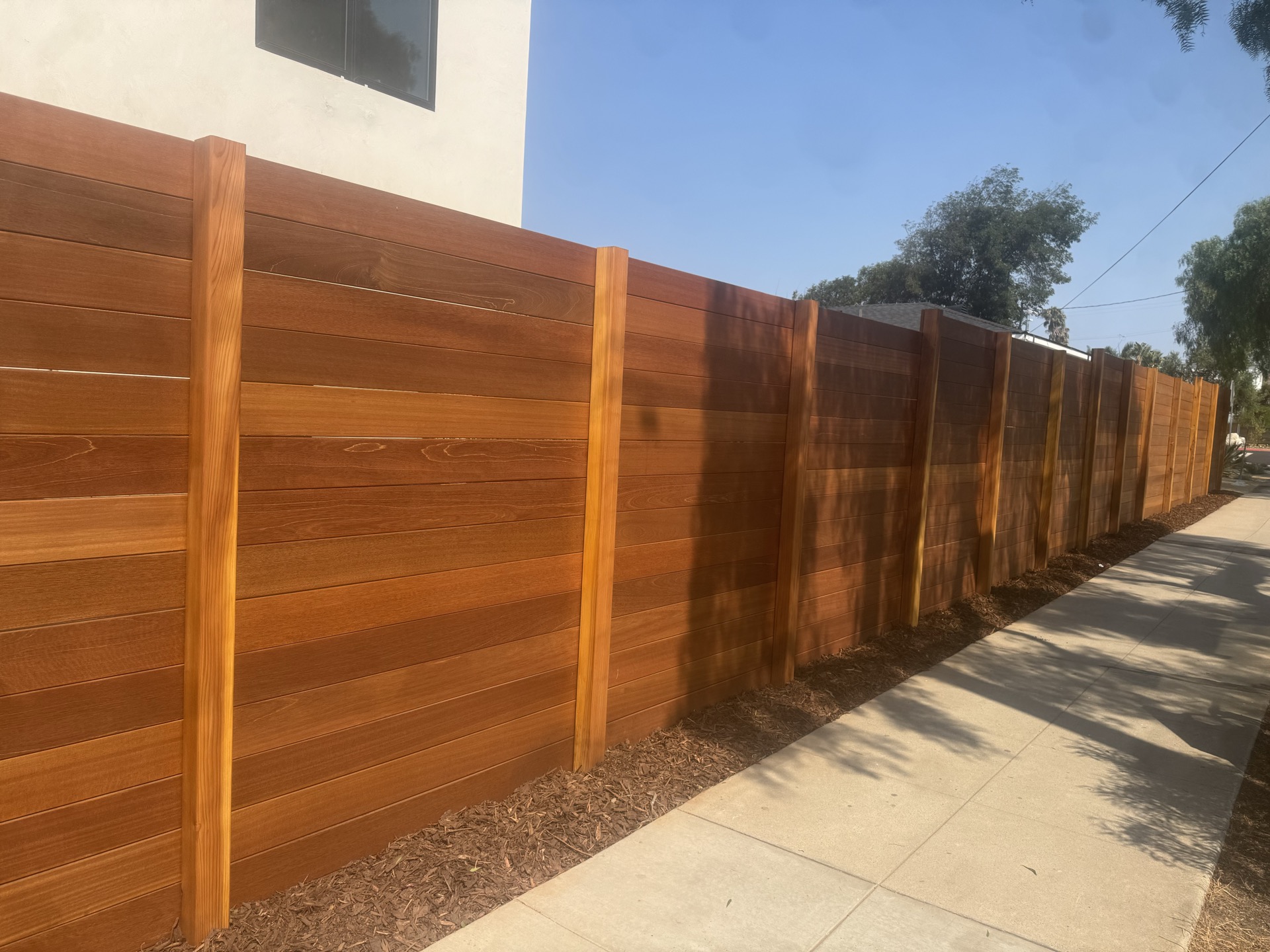 Long run of hardwood privacy fencing
