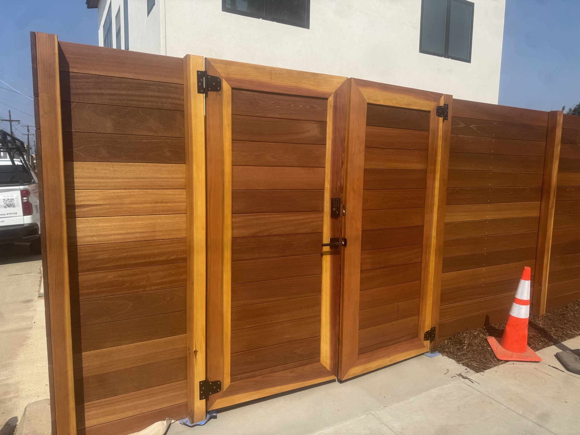 Mangaris hardwood horizontal fence with custom gate in San Diego
