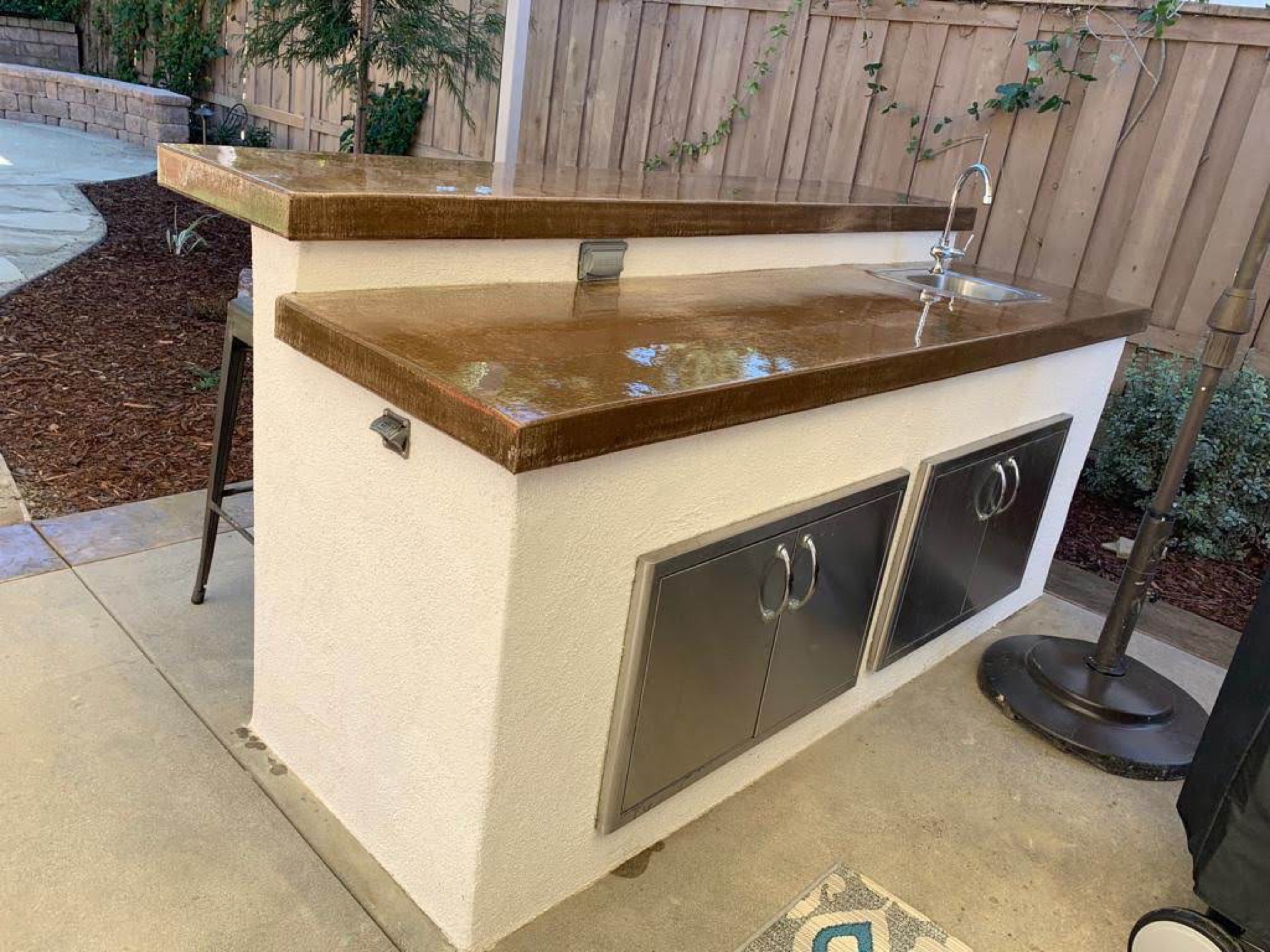 Stucco outdoor kitchen with colored concrete countertop