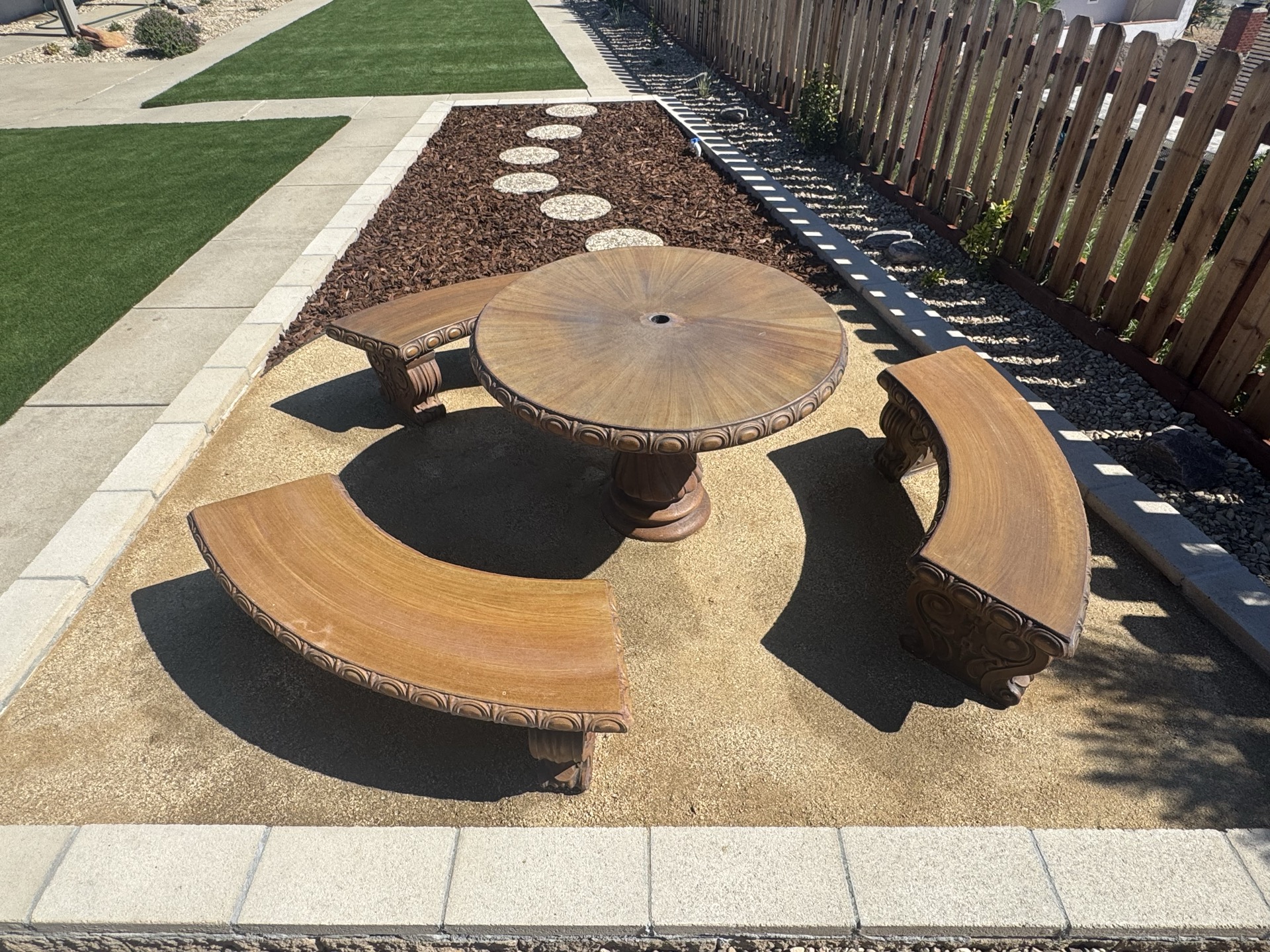 Custom stone fire table and seating area in San Diego backyard