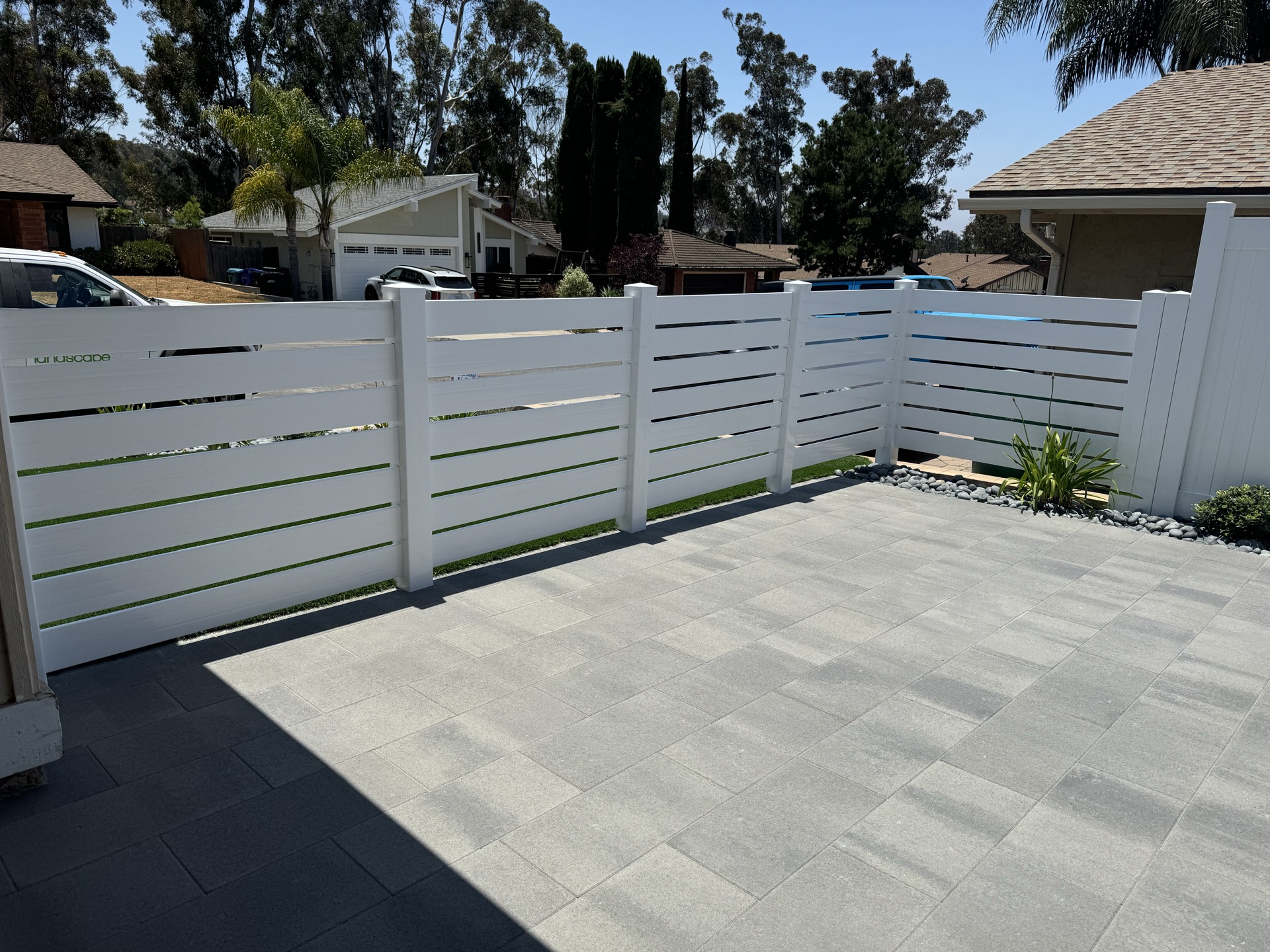 Paver patio with vinyl fencing in San Diego backyard