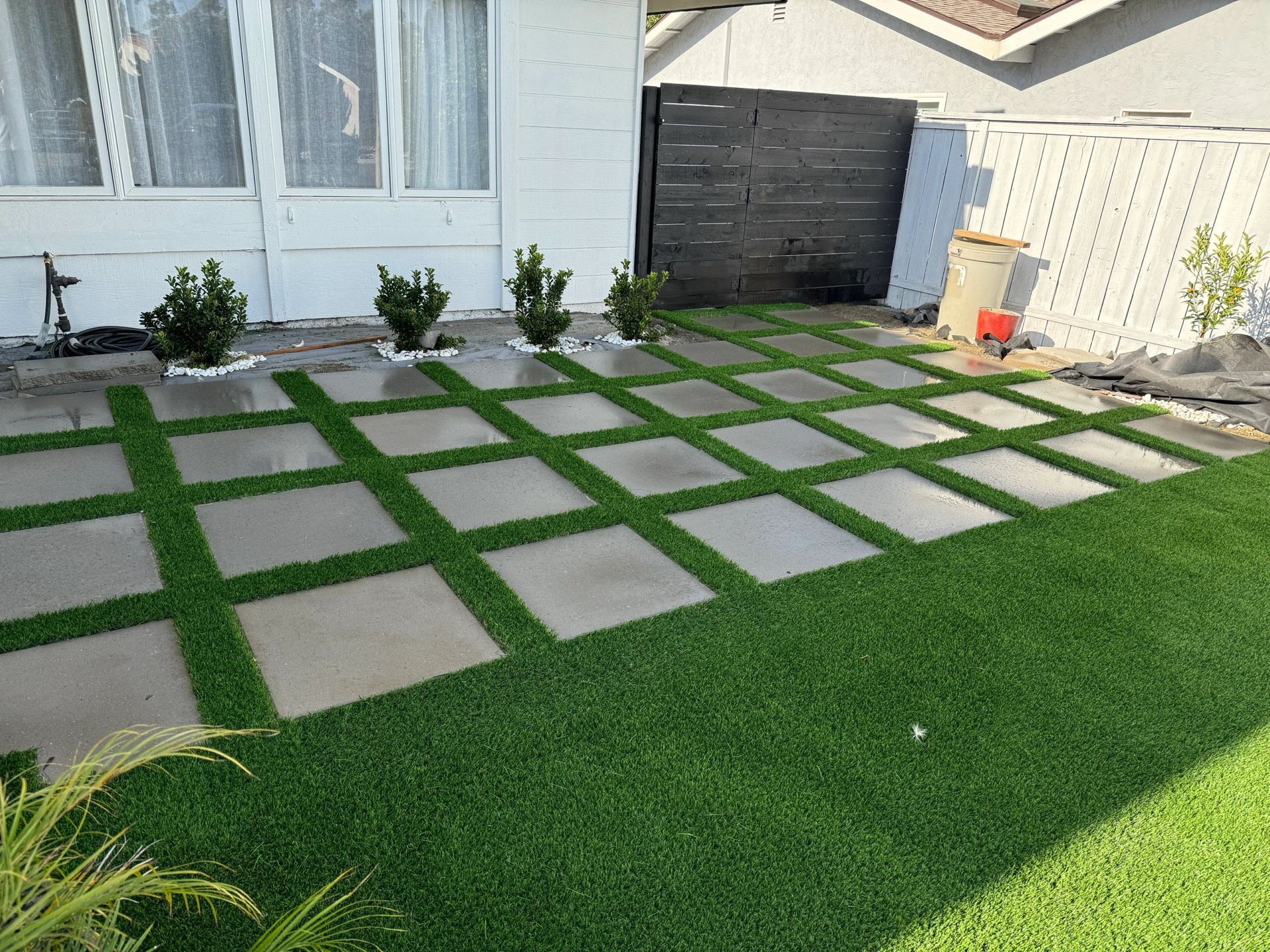 Paver grid with turf and white rock landscaping