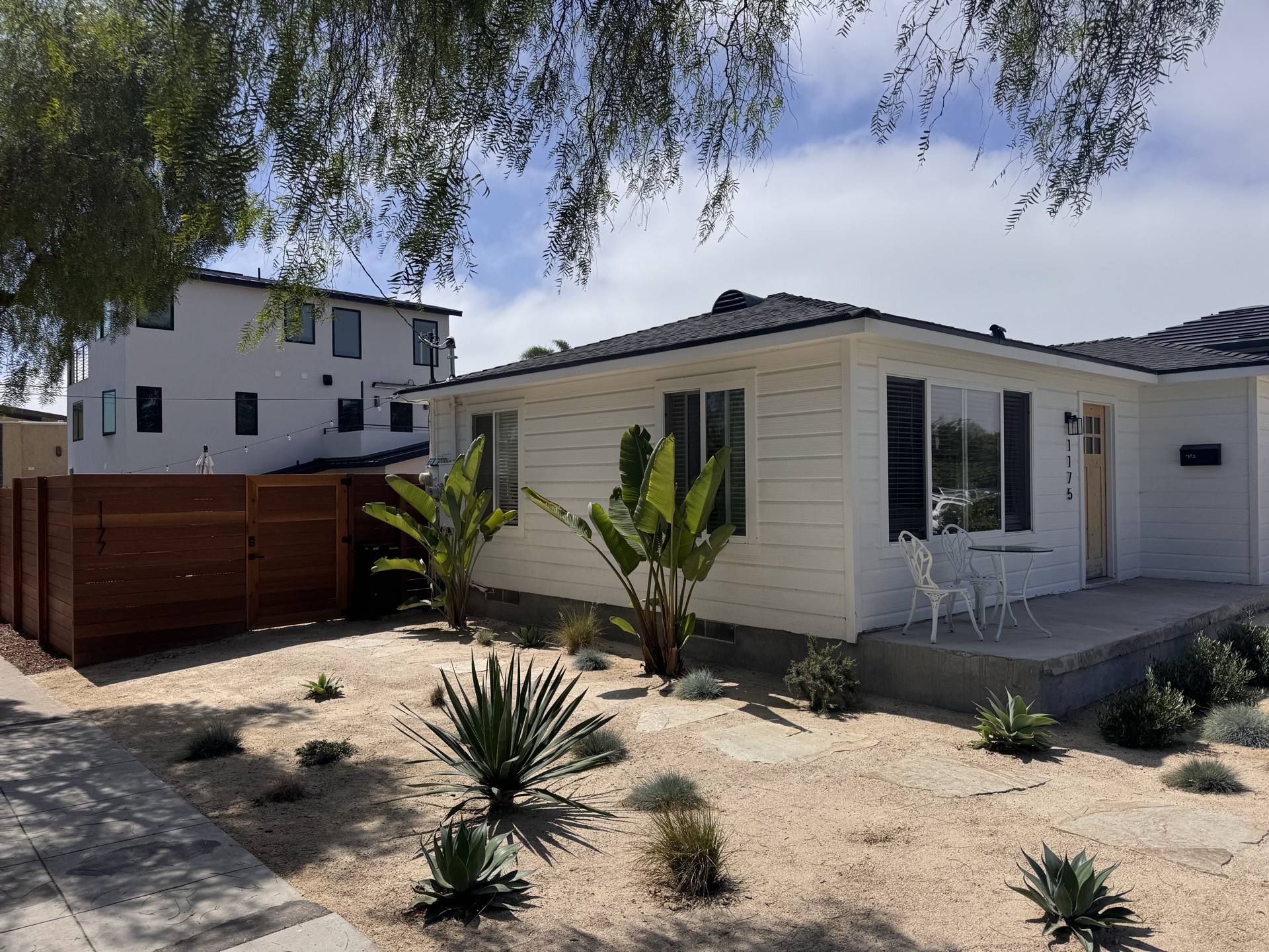 Landscape design with hardwood fence, DG pathways, and planting beds