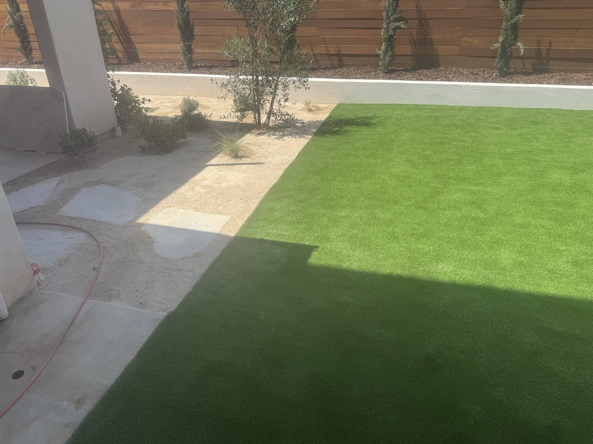 Landscape featuring turf, DG areas, and planting zones