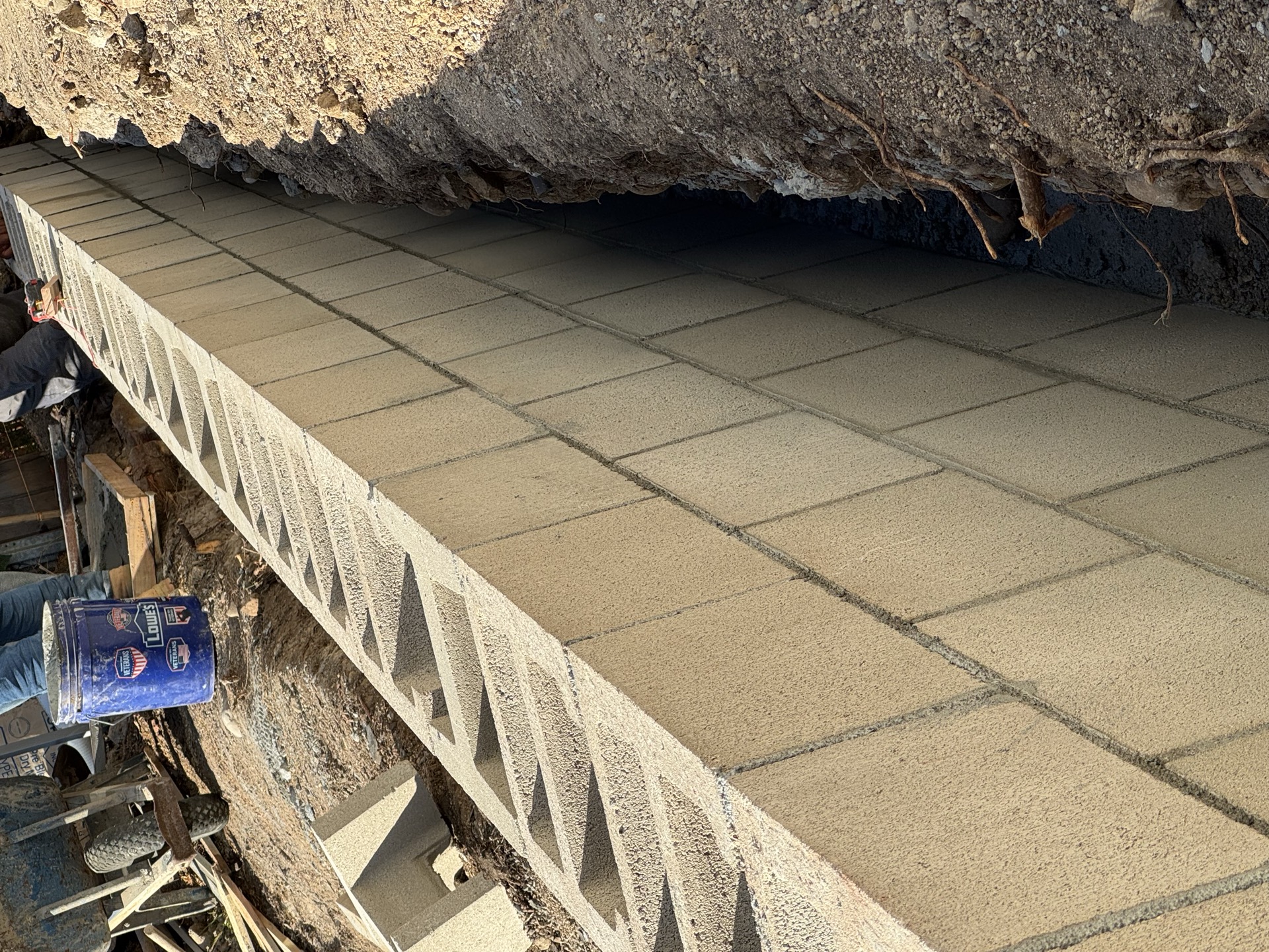 Paver walkway with metal edging under construction in San Diego
